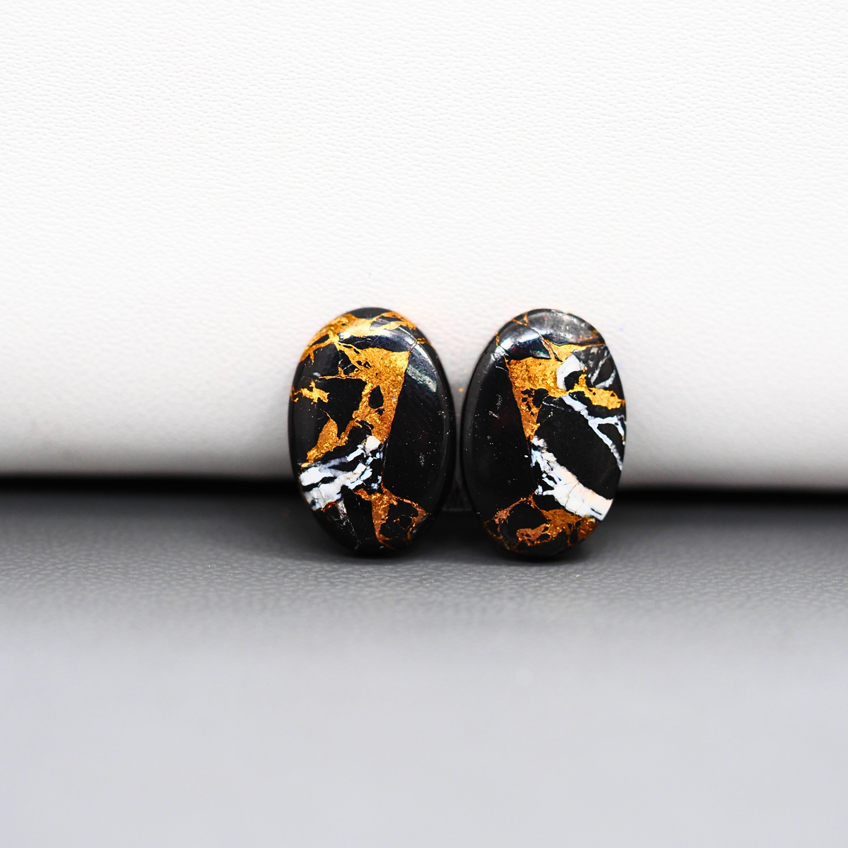 Kingman Black Buffalo Copper Composite Oval Cabochon Pair 15x10x3mm 9ct - black stone with bright copper veins - Pedra Gems