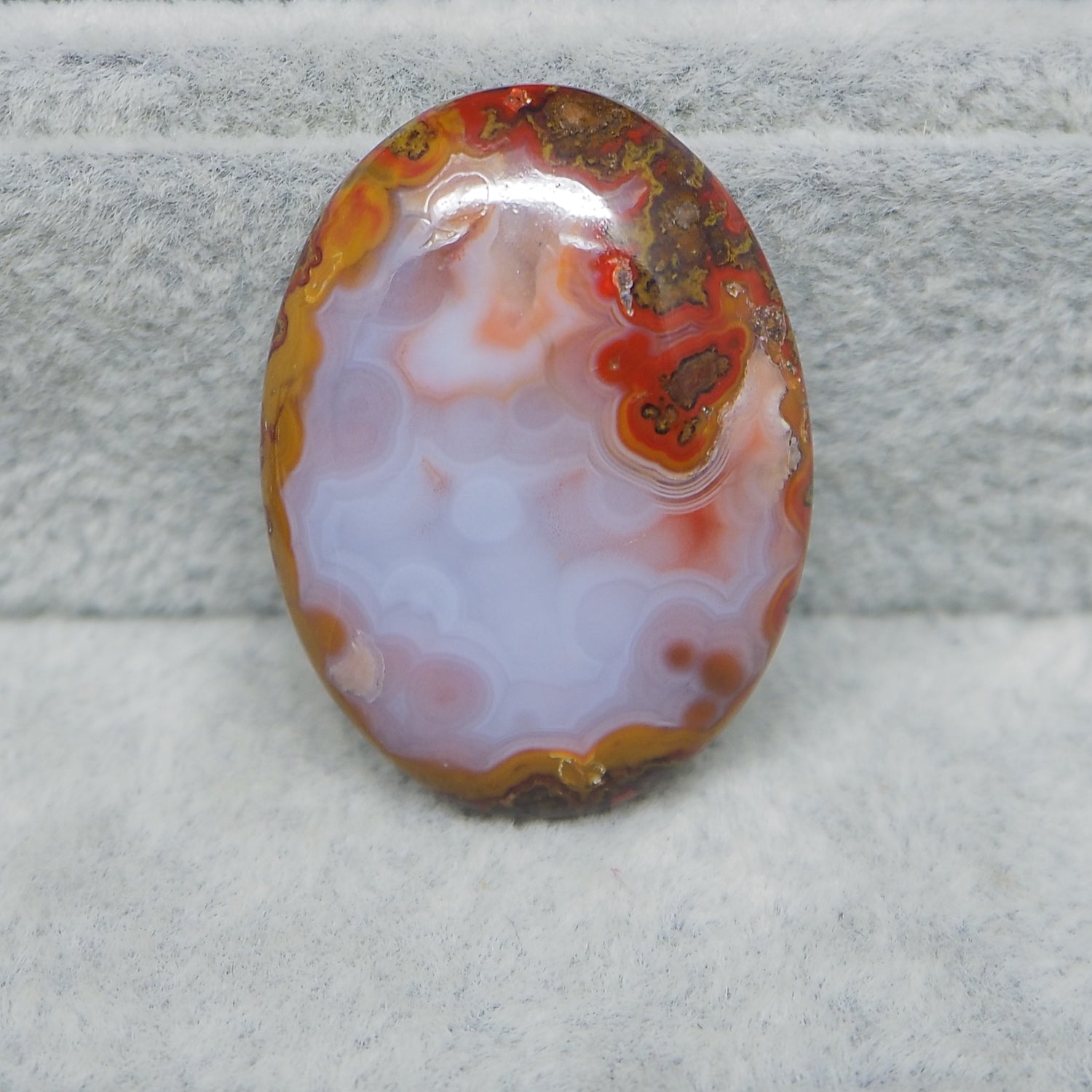 Seam Agate oval cabochon 30x22mm next to ruler for size reference
