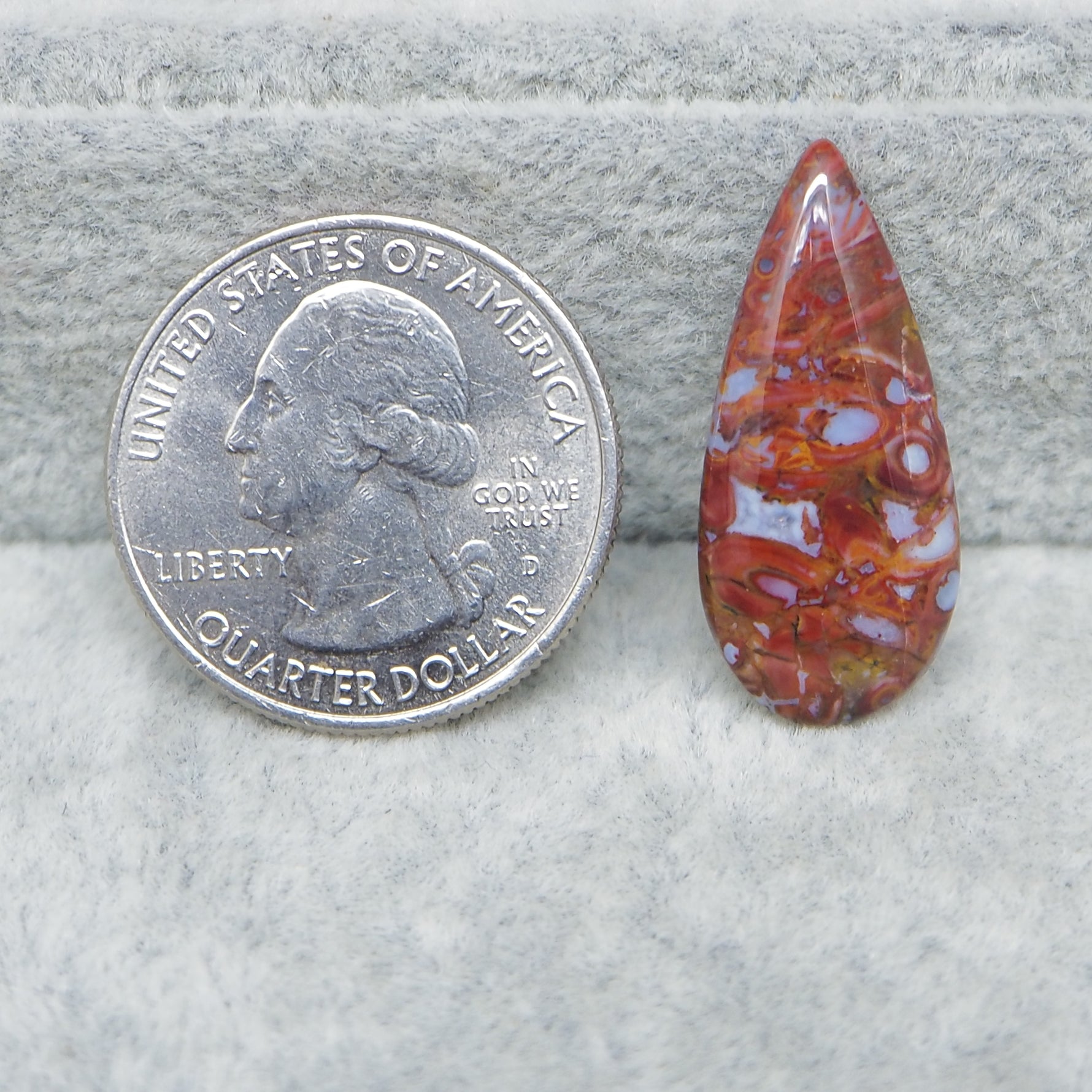 Seam Agate pear cabochon 27x12mm next to ruler for size reference