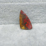 Multicolored stone on a textured gray surface