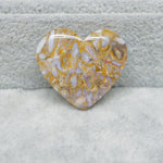 Heart-shaped marbled stone on a textured surface