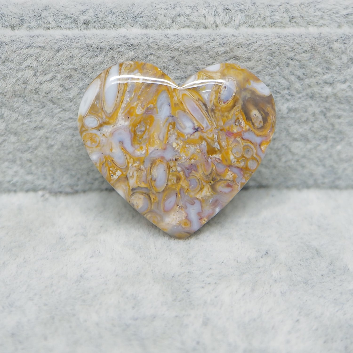 Heart-shaped marbled stone on a textured surface