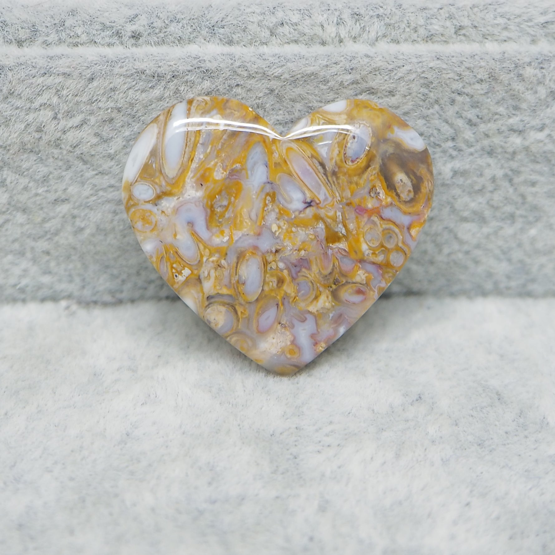 Heart-shaped marbled stone on a textured surface