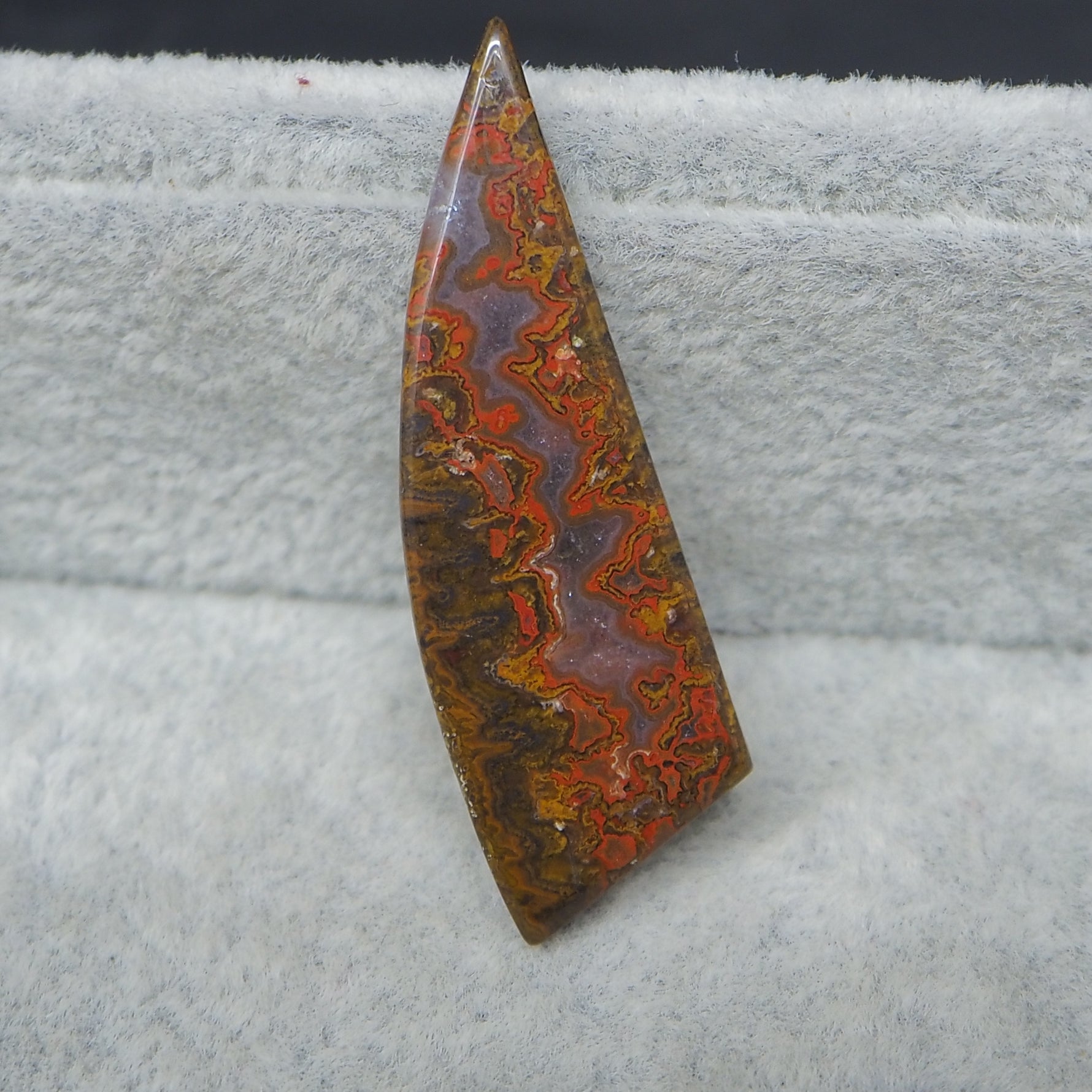 Decorative stone with colorful patterns on a textured surface