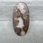 Oval-shaped agate stone on a textured gray background