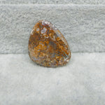 Rusty metal object on a textured gray surface