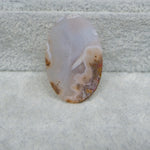Polished agate stone on a textured white surface