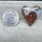 Heart-shaped agate stone next to a U.S. quarter dollar on a gray background