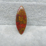 Multicolored stone on a textured gray background