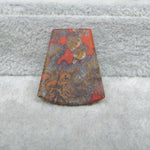 Rust-colored metal object on a textured gray surface