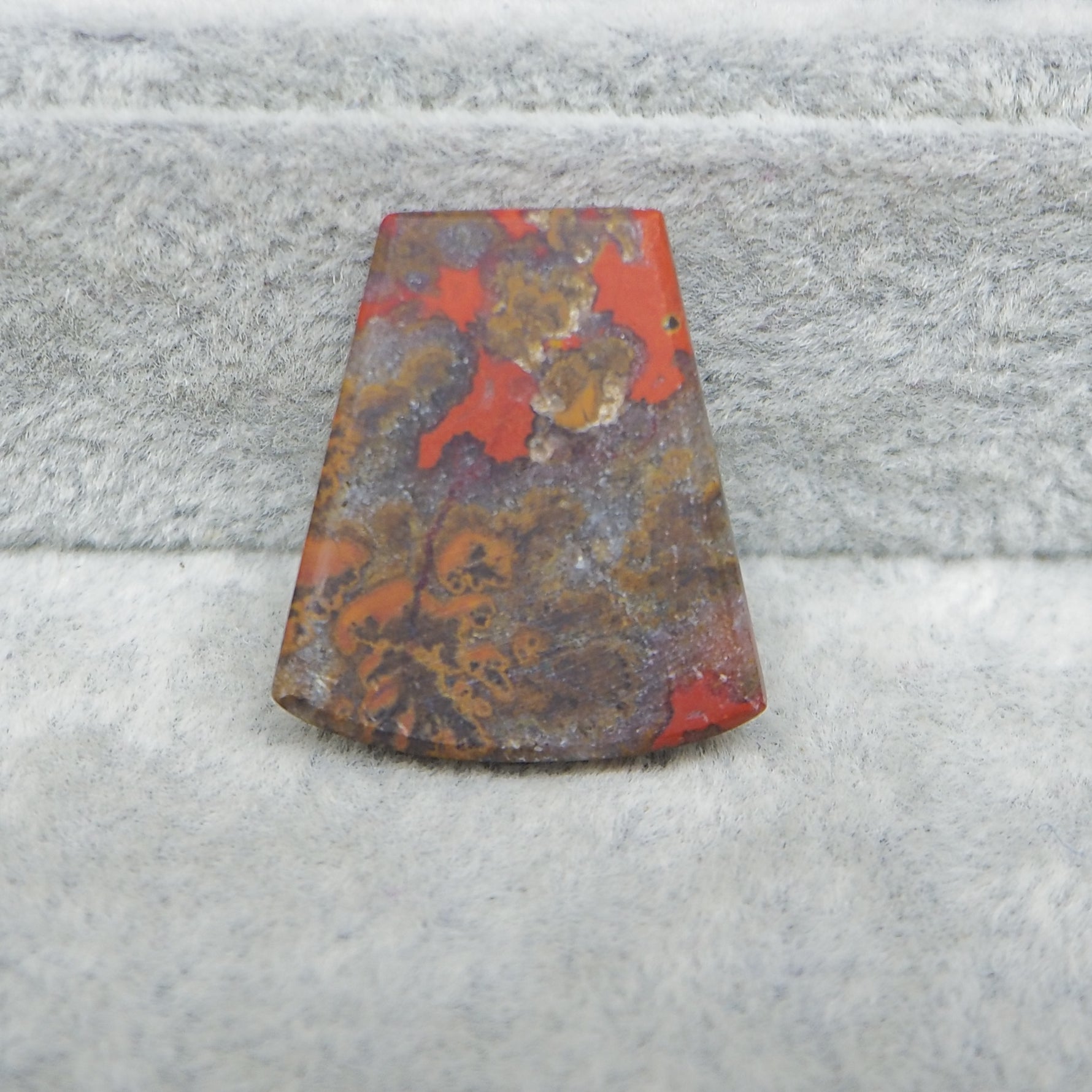Rust-colored metal object on a textured gray surface