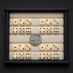 Set of dice with a quarter coin for size comparison on a dark background