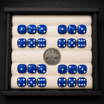 Set of blue dice with white dots arranged in a display case, accompanied by a silver coin.