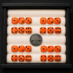 Set of orange dice with black pips in a display case, showing a quarter coin for scale.