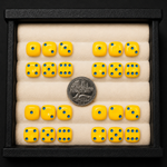 Yellow dice with blue dots arranged in a grid on a black border with a coin for scale.