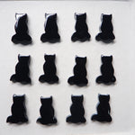 Black cat-shaped objects arranged in a grid on a white background