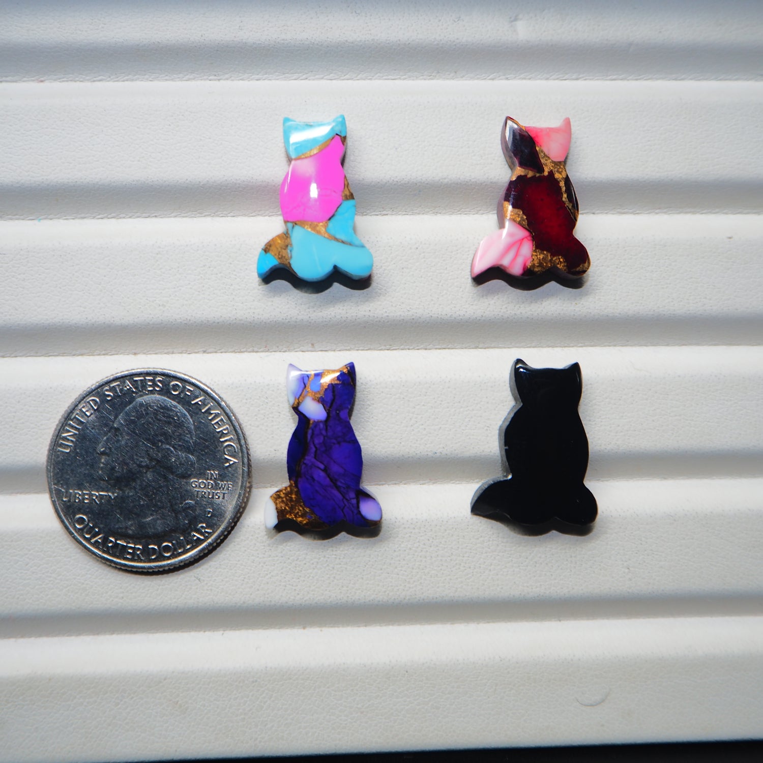 Cat shape cabochon collection 4 colour variants display Pedra Gems quarter dollar size reference