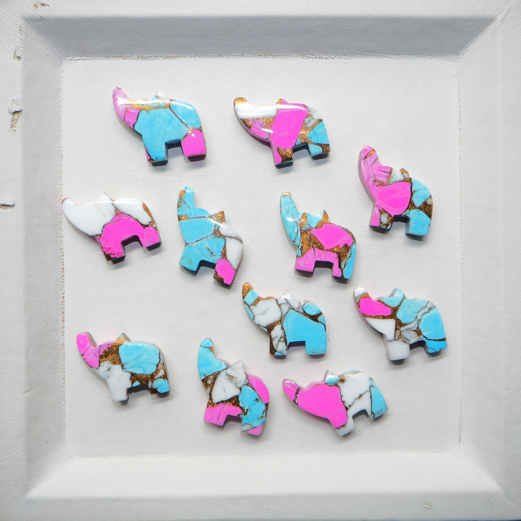Colorful elephant-shaped cookies on a white tray