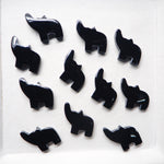 Black elephant-shaped objects on a white background