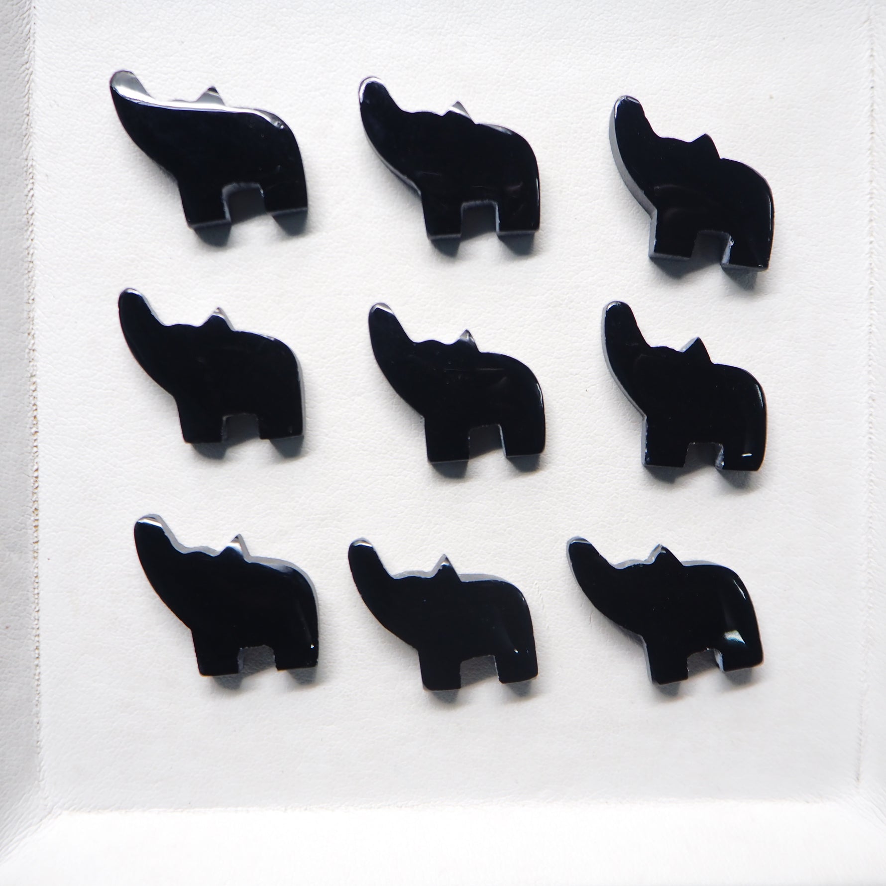 Black elephant-shaped earrings on a white background