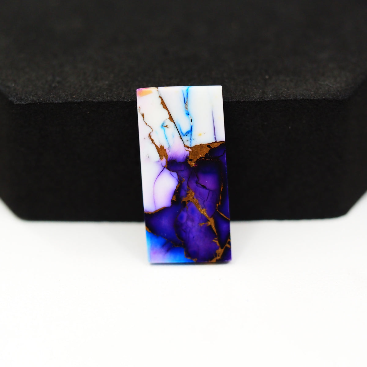 Purple Ice Rose Dahlia baguette cabochon 24x12mm next to US quarter dollar for size reference