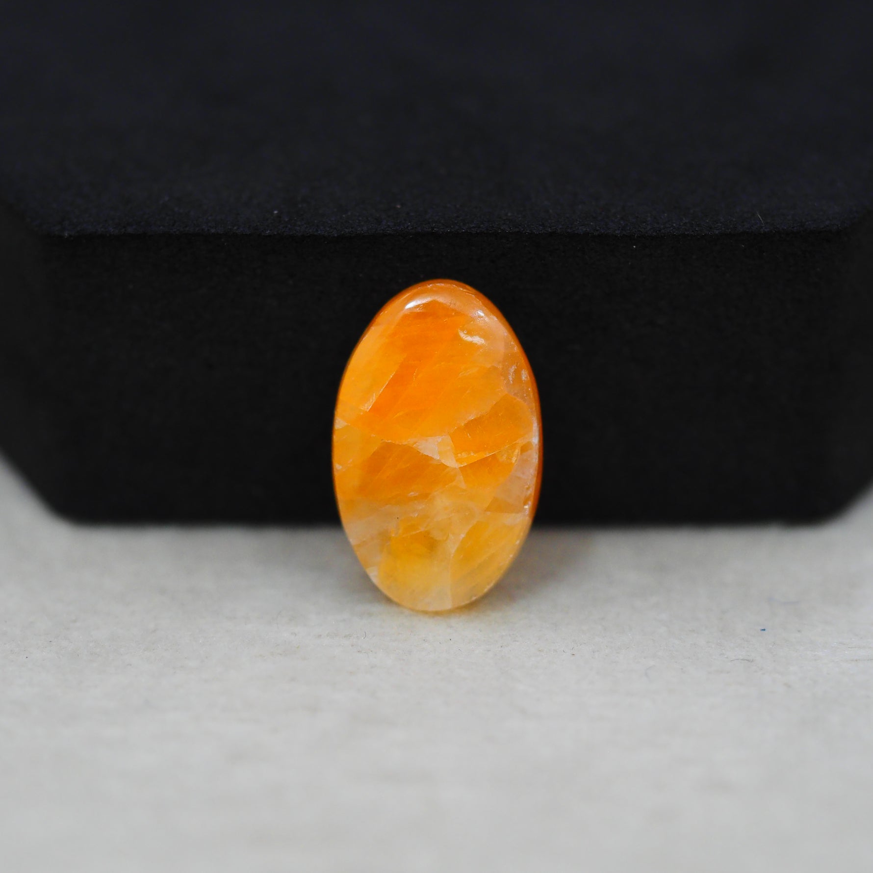Natural Orange Calcite Oval Cabochon 19x12mm 10.5ct - warm honey-orange - Pedra Gems.