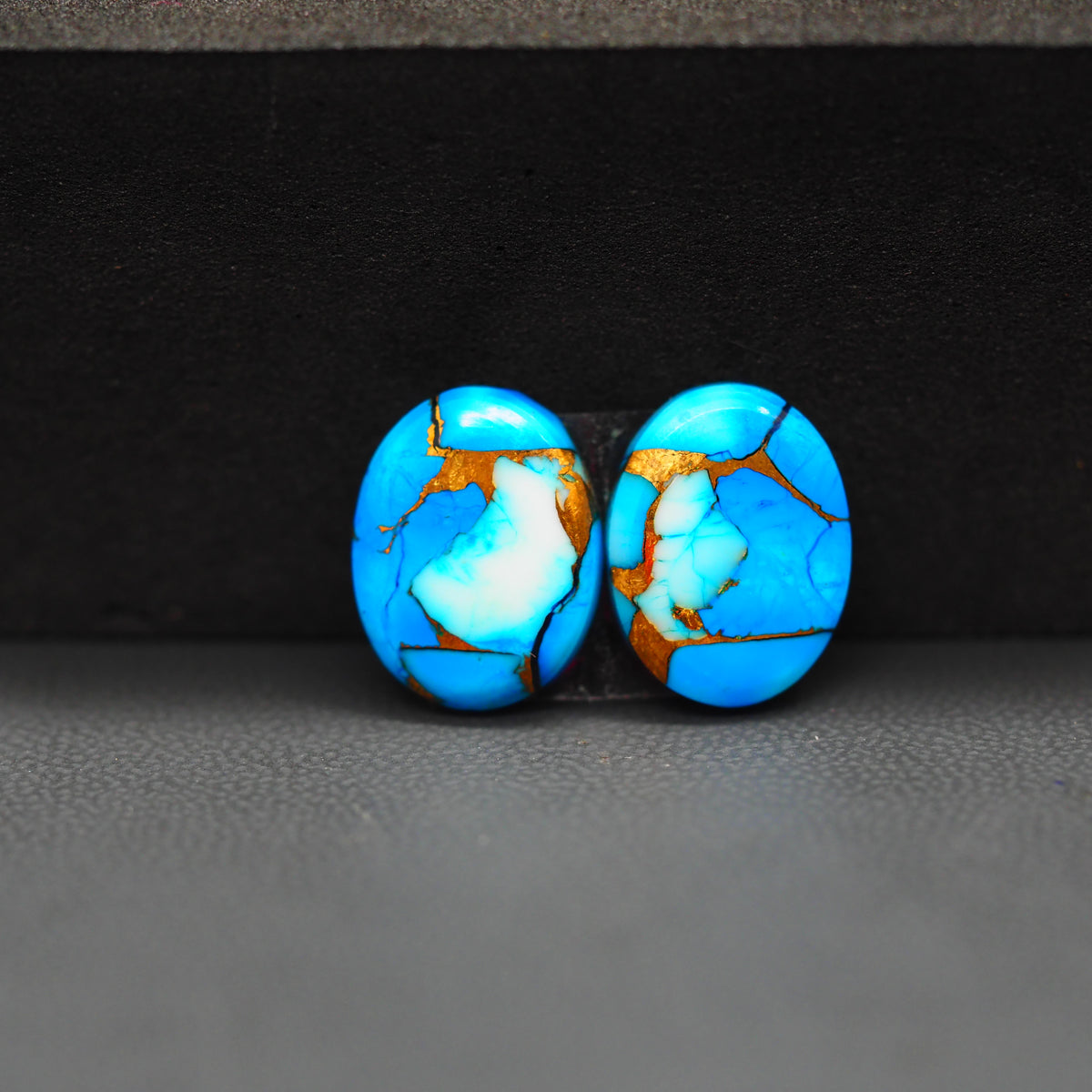Kingman Ice Blue Dahlia Oval Cabochon Pair 14x11x3mm 9ct - icy blue and white stone with copper veining - Pedra Gems