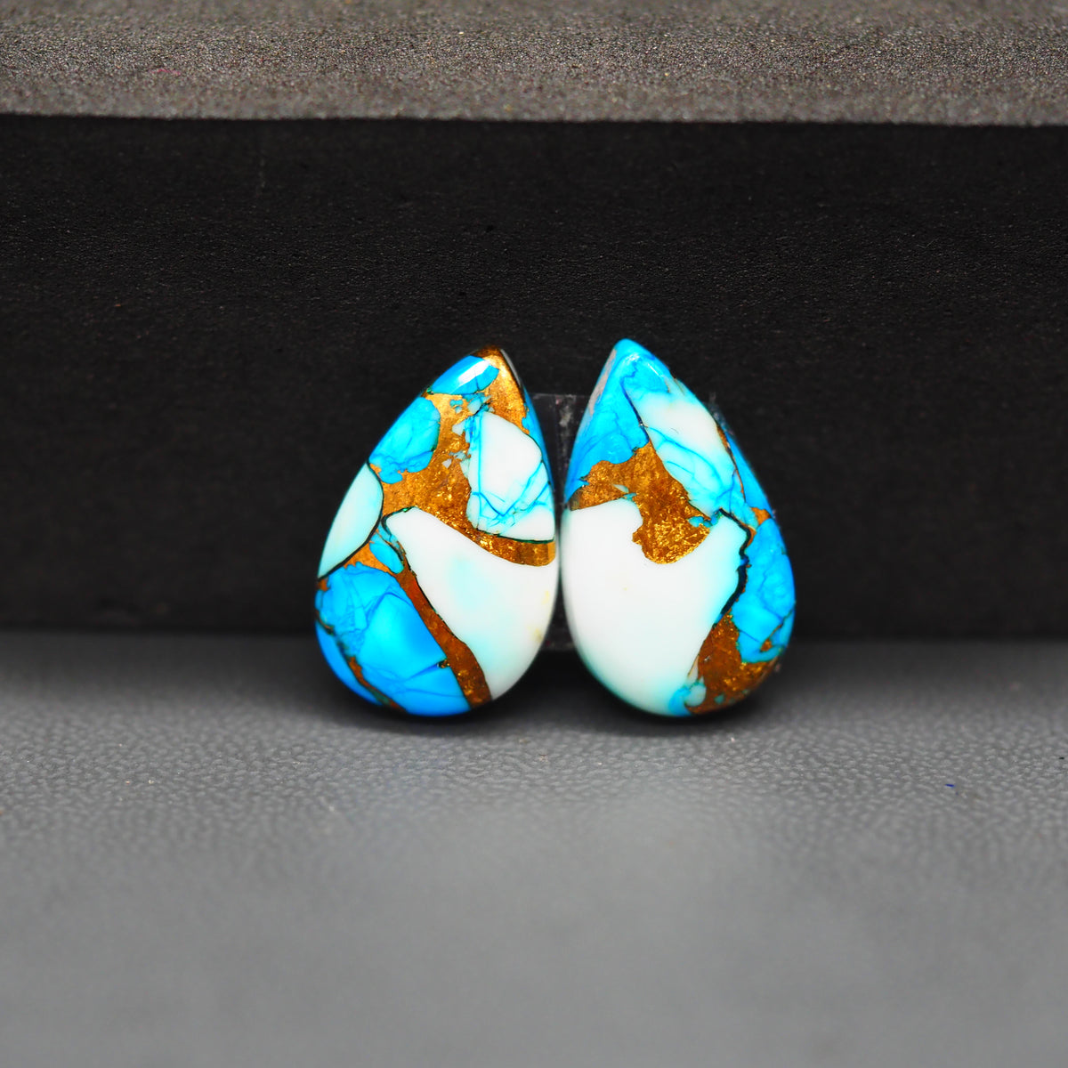 Kingman Ice Blue Dahlia Pear Cabochon Pair 18x11x3mm 11.5ct - icy blue and white stone with copper veining - Pedra Gems