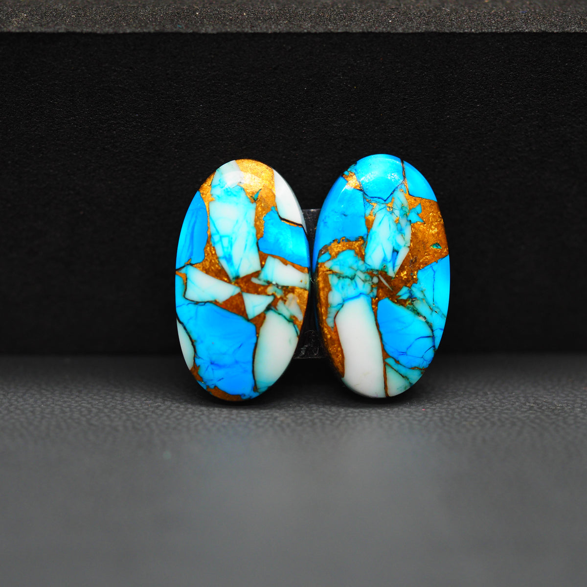Kingman Ice Blue Dahlia Composite Oval Cabochon Pair 20x11x3mm 14ct - icy blue and white stone with copper veining - Pedra Gems