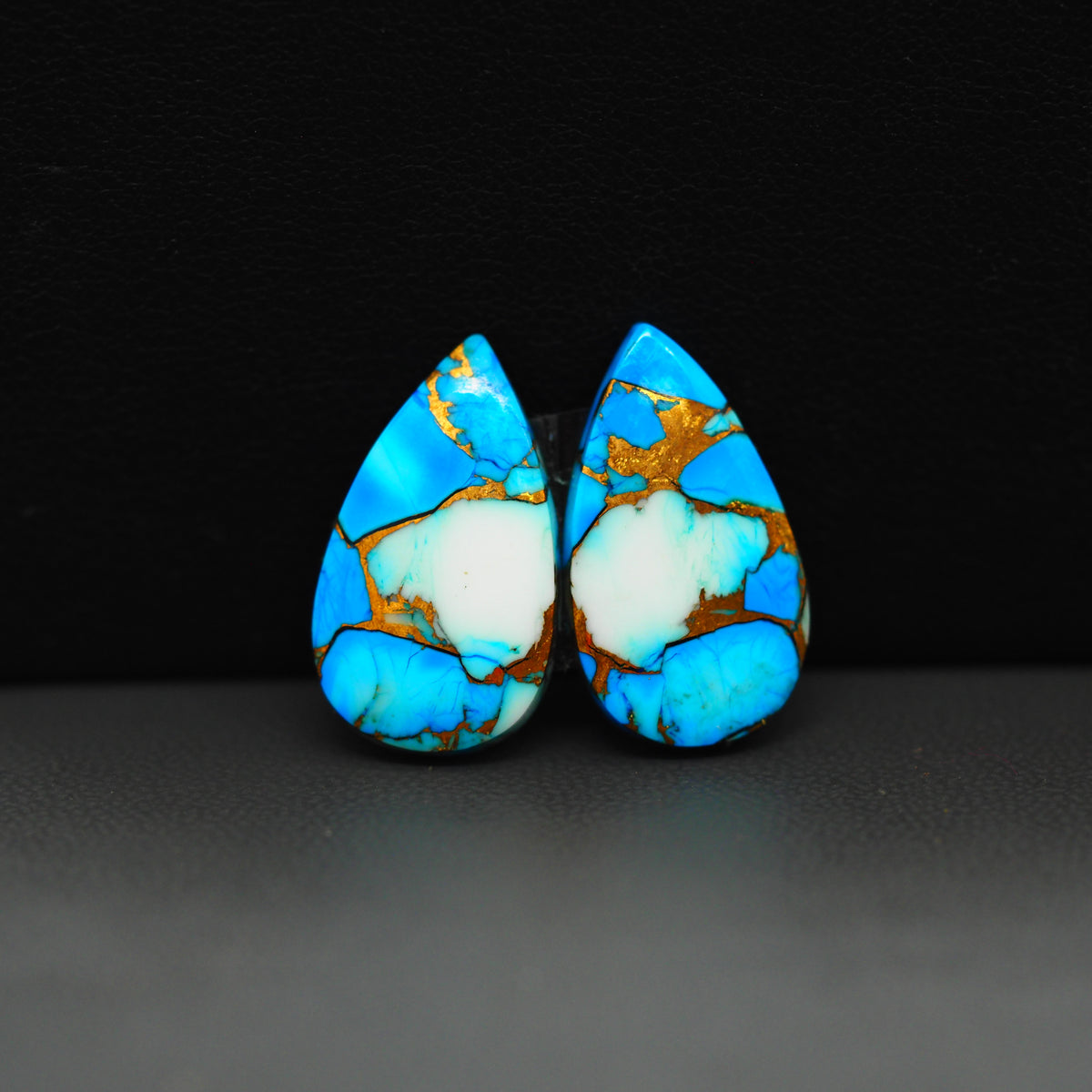 Kingman Ice Blue Dahlia Composite Pear Cabochon Pair 21x12x3mm 14ct - icy blue and white stone with copper veining - Pedra Gems