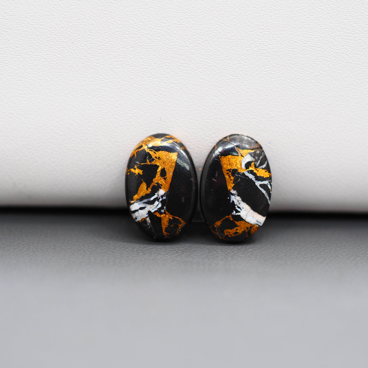 Kingman Black Buffalo Copper Composite Oval Cabochon Pair 15x10x3mm 9ct - black stone with bright copper veins - Pedra Gems