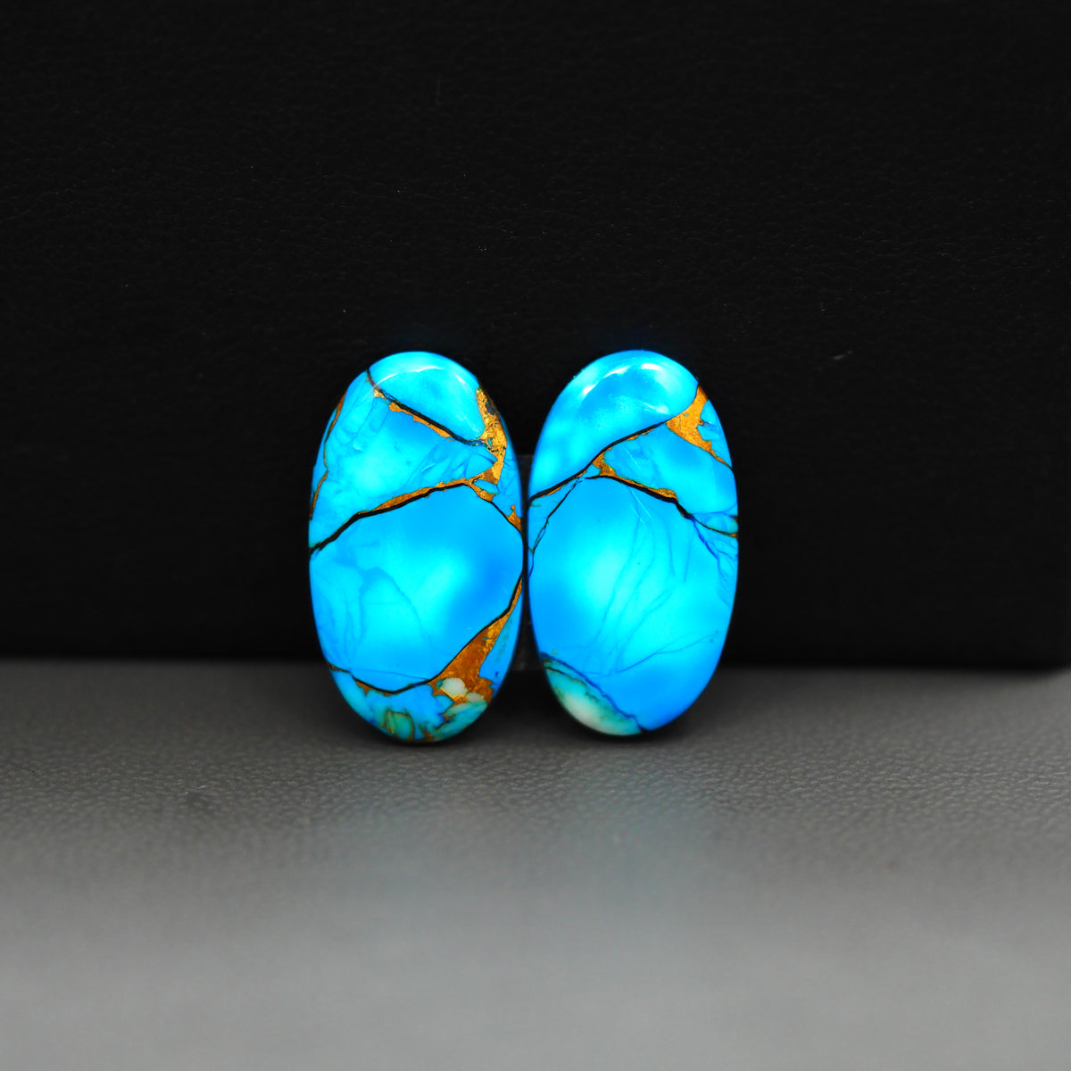 Kingman Ice Blue Dahlia Composite Oval Cabochon Pair 20x11x3mm 14ct - icy blue and white stone with copper veining - Pedra Gems