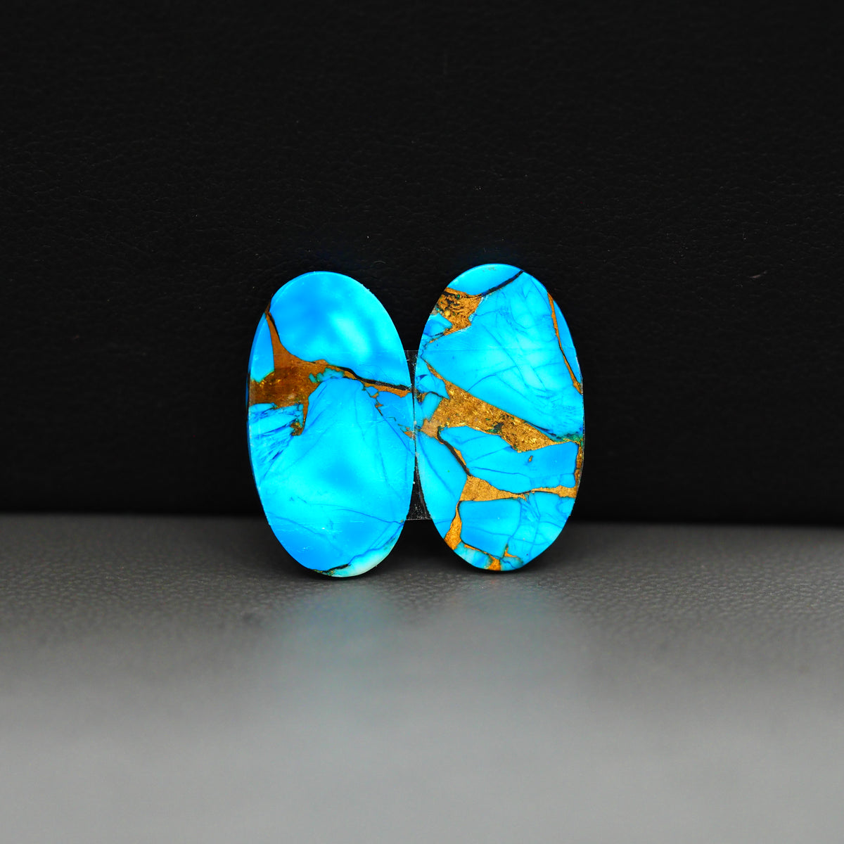 Kingman Ice Blue Dahlia Composite Oval Cabochon Pair 20x11x3mm 14ct - icy blue and white stone with copper veining - Pedra Gems