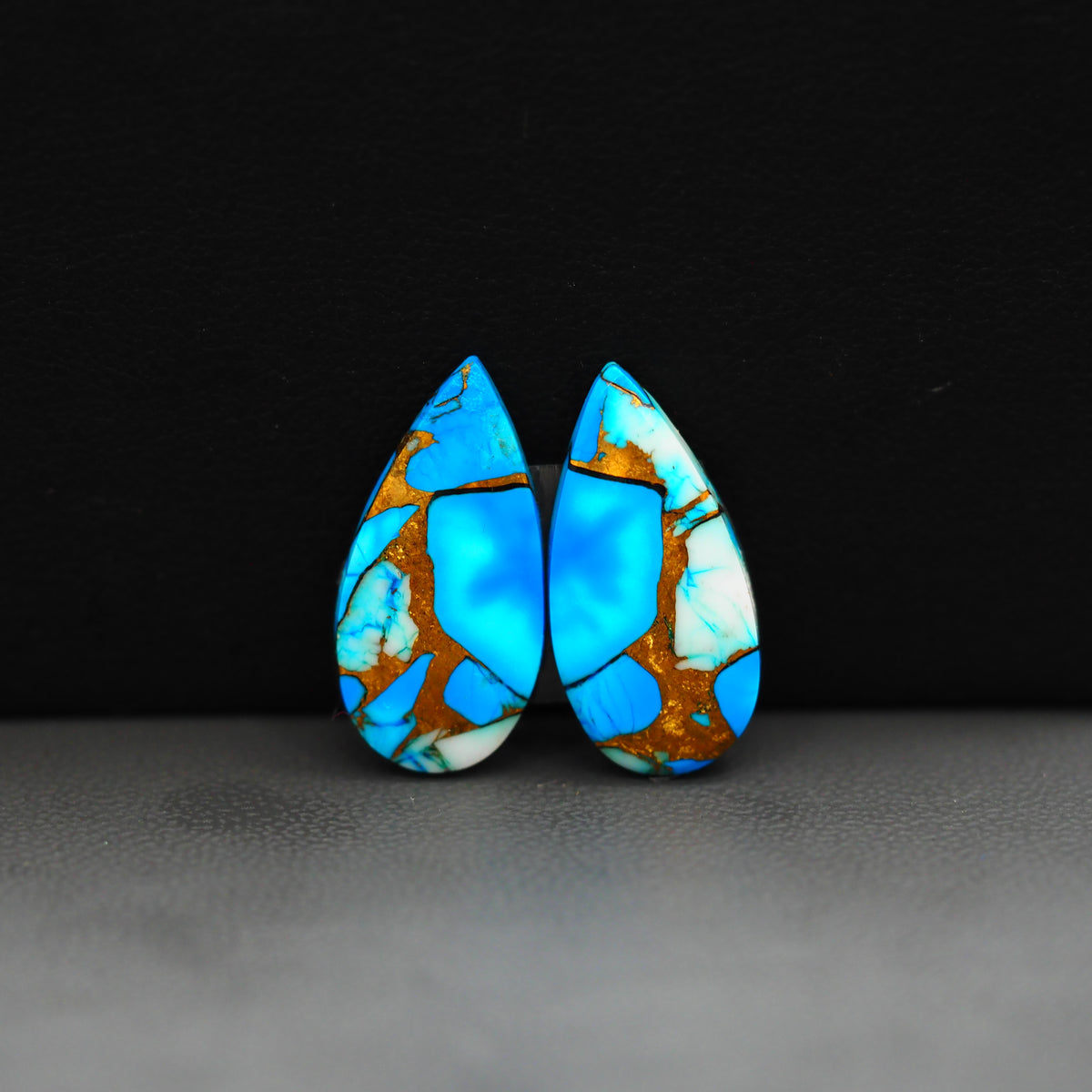 Kingman Ice Blue Dahlia Composite Pear Cabochon Pair 21x11x3mm 14ct - icy blue and white stone with copper veining - Pedra Gems