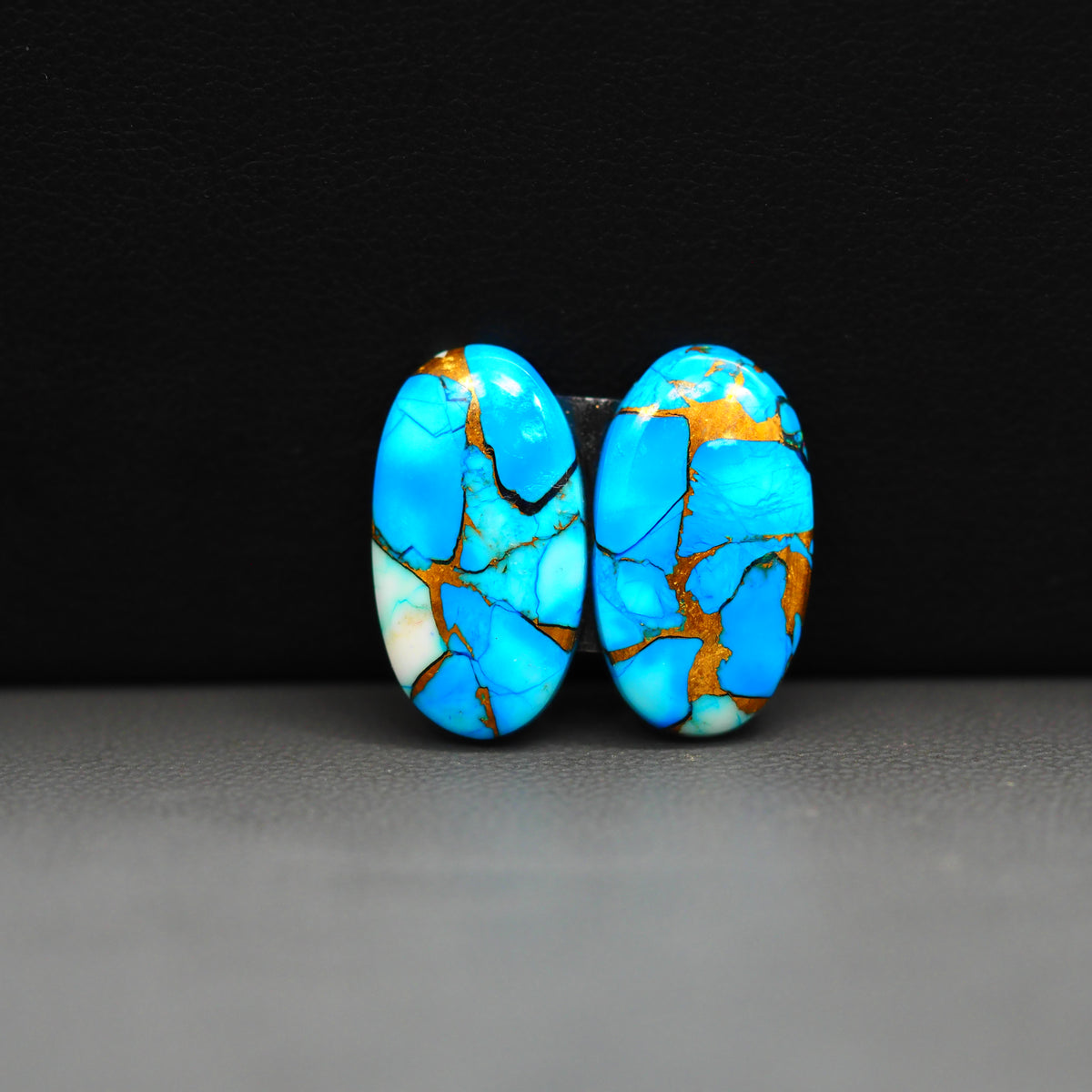 Kingman Ice Blue Dahlia Composite Oval Cabochon Pair 19x11x3mm 12ct - icy blue and white stone with copper veining - Pedra Gems