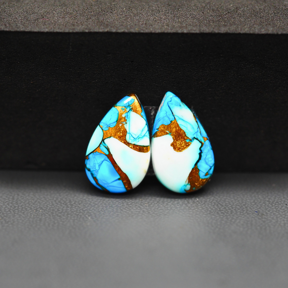 Kingman Ice Blue Dahlia Pear Cabochon Pair 18x11x3mm 11.5ct - icy blue and white stone with copper veining - Pedra Gems