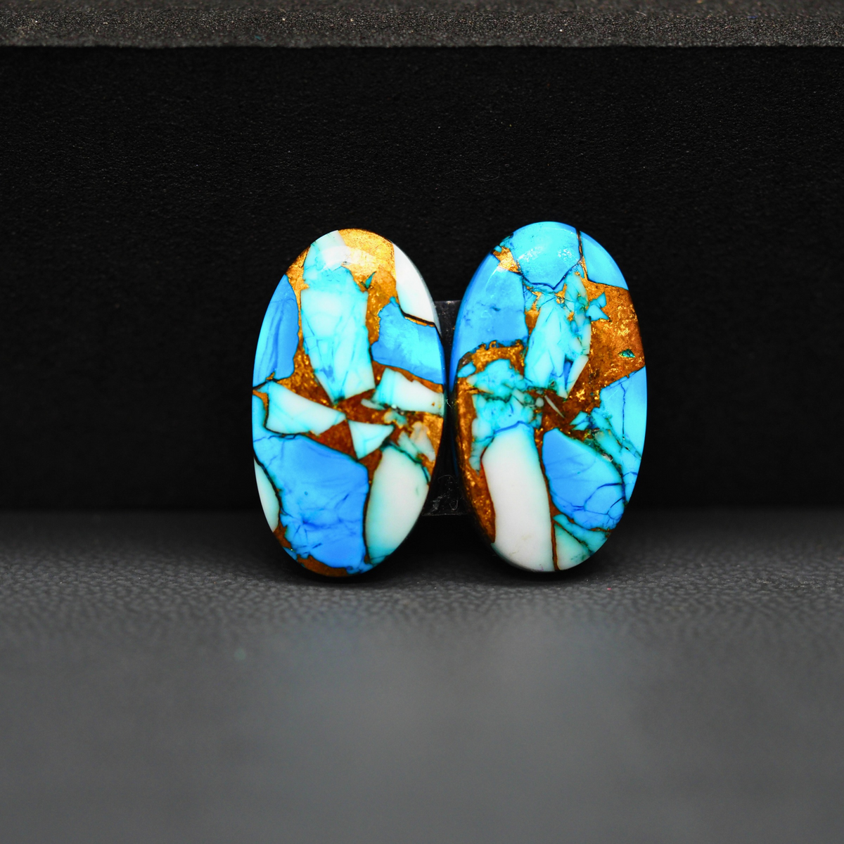Kingman Ice Blue Dahlia Composite Oval Cabochon Pair 20x11x3mm 14ct - icy blue and white stone with copper veining - Pedra Gems