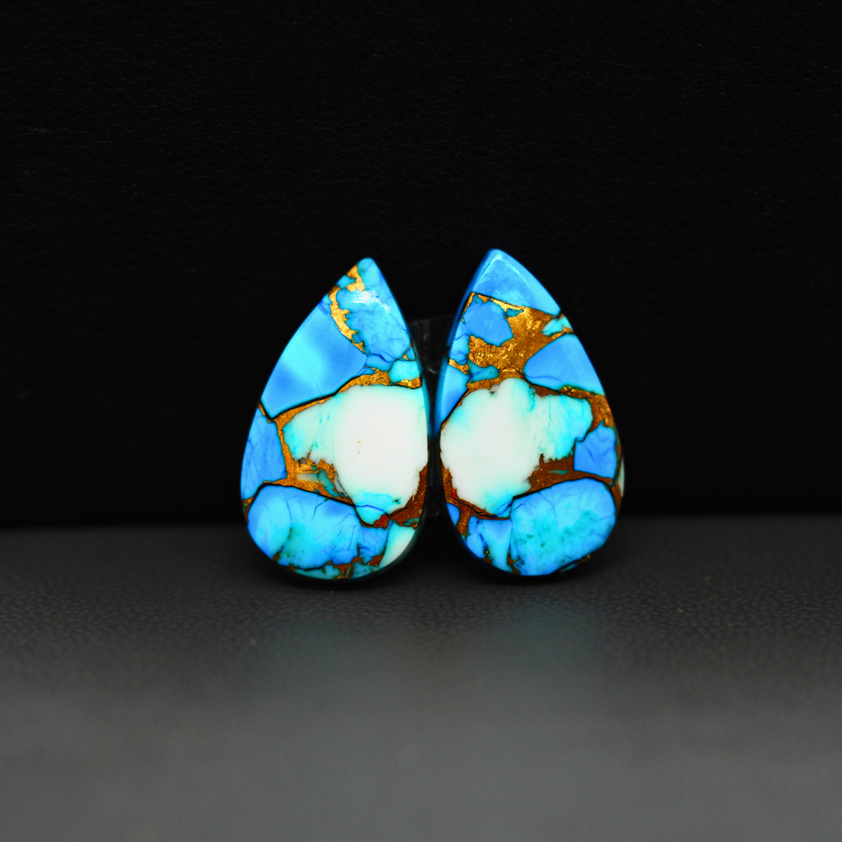 Kingman Ice Blue Dahlia Composite Pear Cabochon Pair 21x12x3mm 14ct - icy blue and white stone with copper veining - Pedra Gems