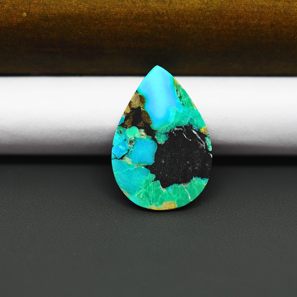 Mohave Turquoise & White Buffalo Pear Cabochon 26x18mm 11ct - Black Panel with Blue and Green - Pedra Gems
